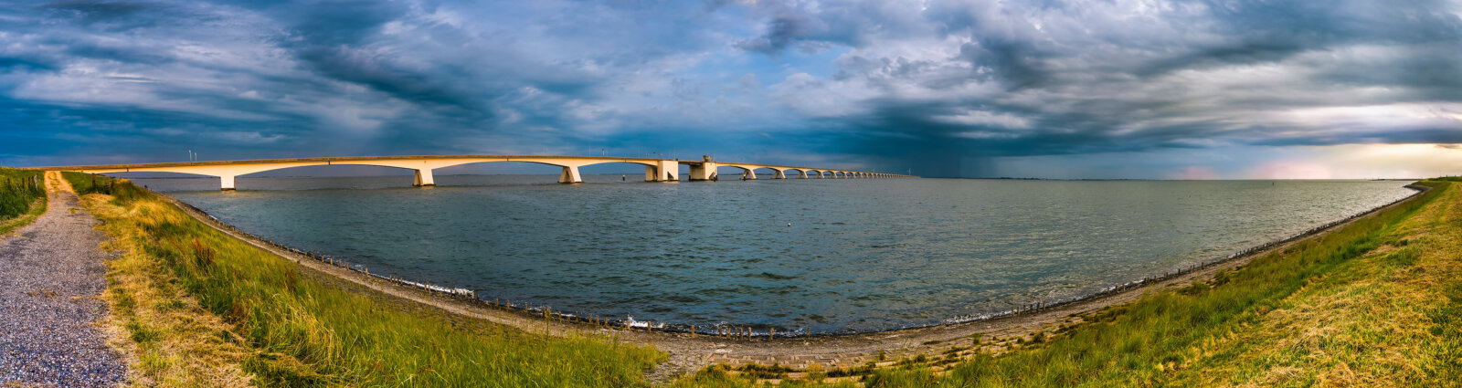 Zeelandbrug A panoramic view of the Zeeland Bridge, with a dark threatening rain shower over the Oosterschelde, seen from Zierikzee.