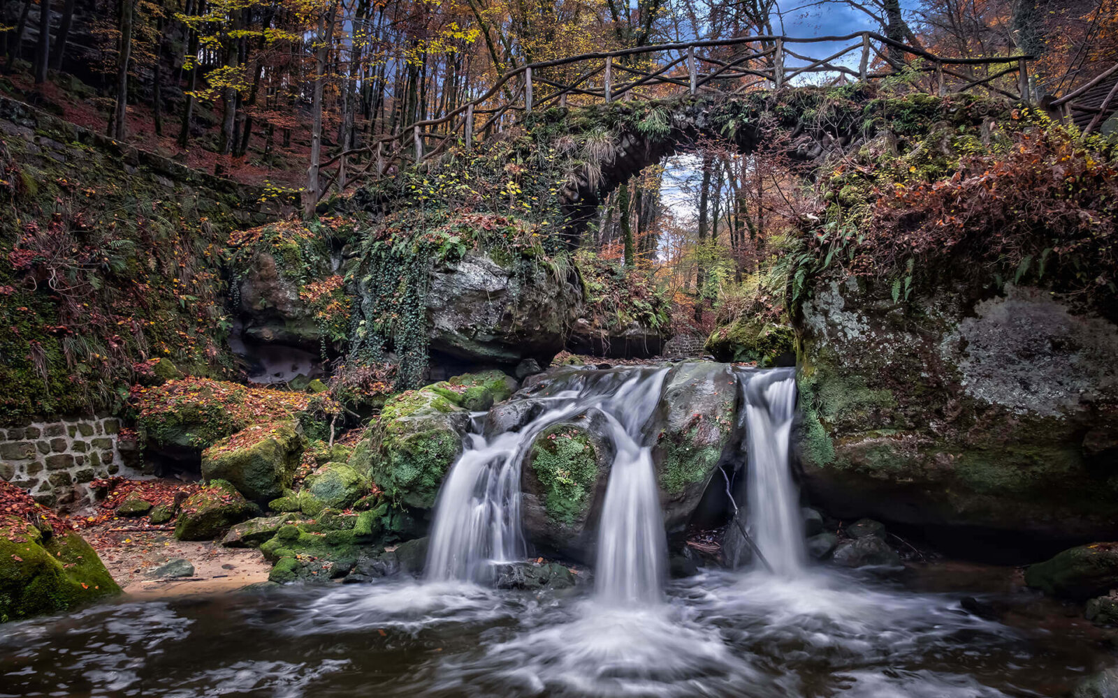 The Schiessentümpel waterfall (with autumn colors) at Müllerthal, Luxembourg.