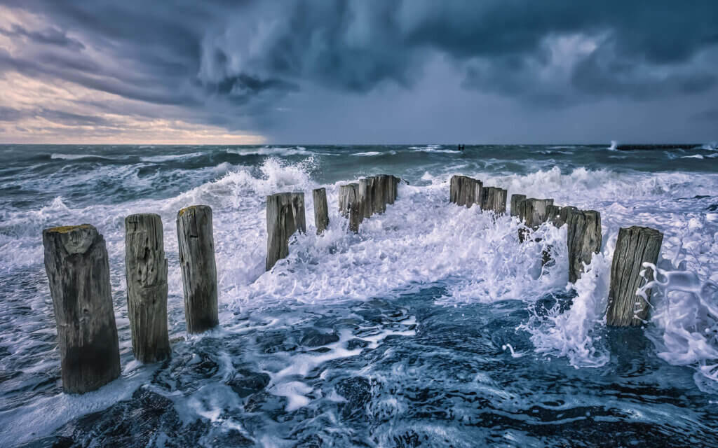 Stormy conditions, with breaking waves under a dark sky, near Westkapelle.