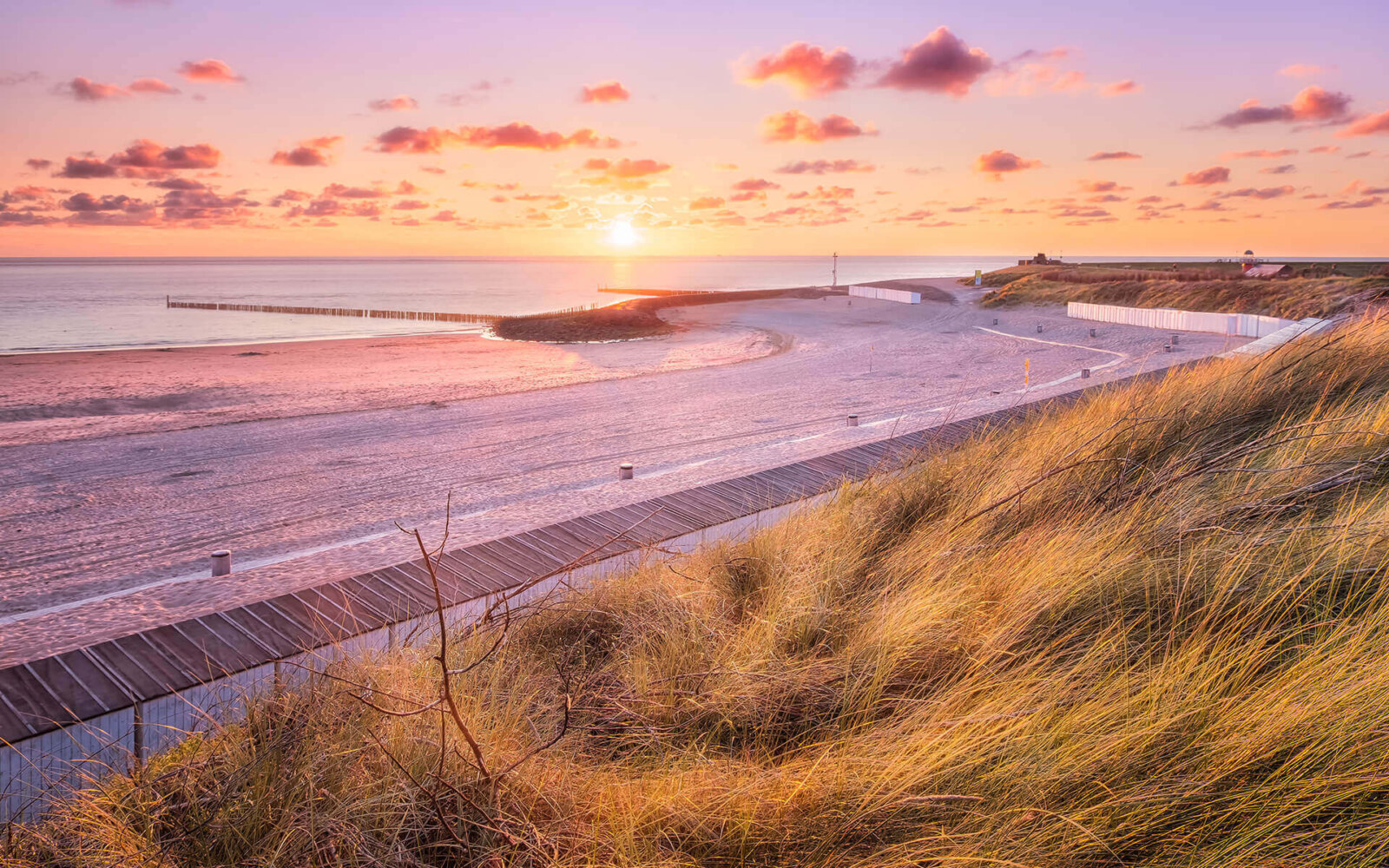 Beautiful sunset, with sheep clouds, at the beach of Westkapelle.