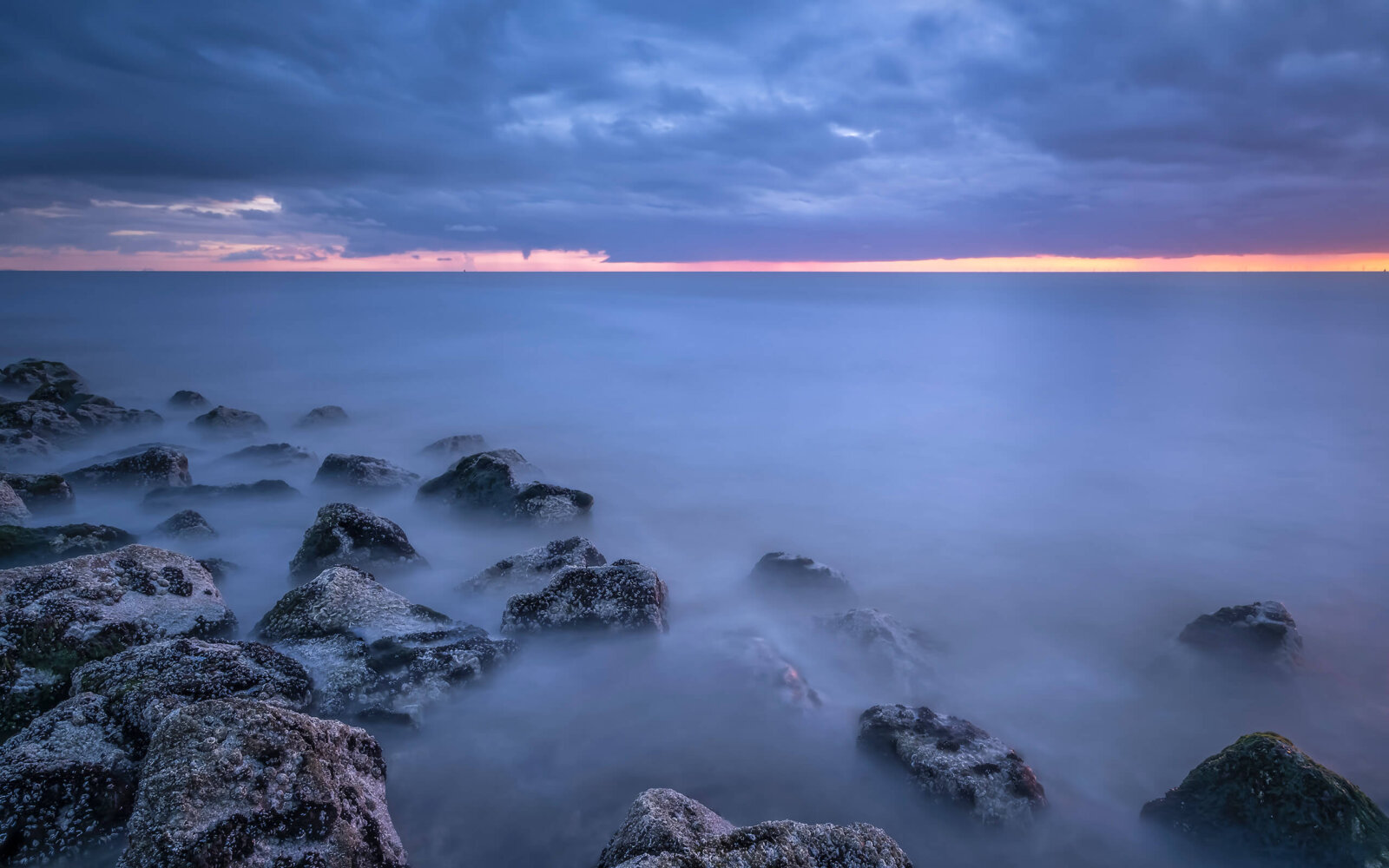 Westkapelle A serene sunset at the basalt blocks with a view of the North Sea at Westkapelle.