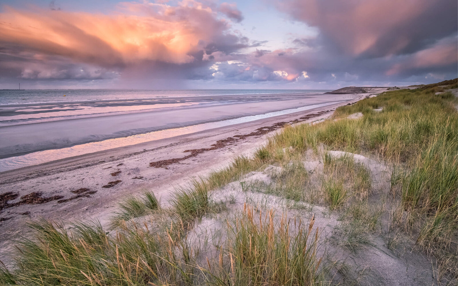 View over dunes, beach and sea with sunrise at Westenschouwen.