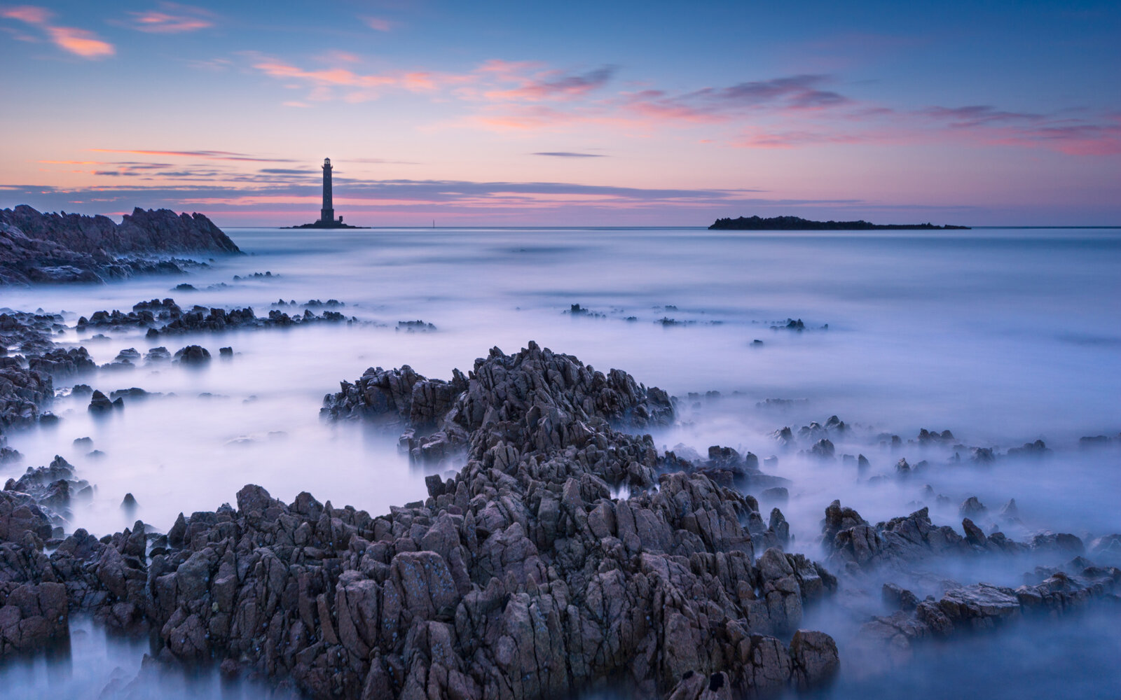 Cap de la Hague The sunset at the lighthouse with rocky coast of Cap de la Hague in Normandy, France.