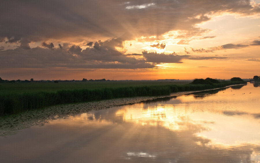 Beautiful sun harp reflected in the river near the hamlet of De Donk.