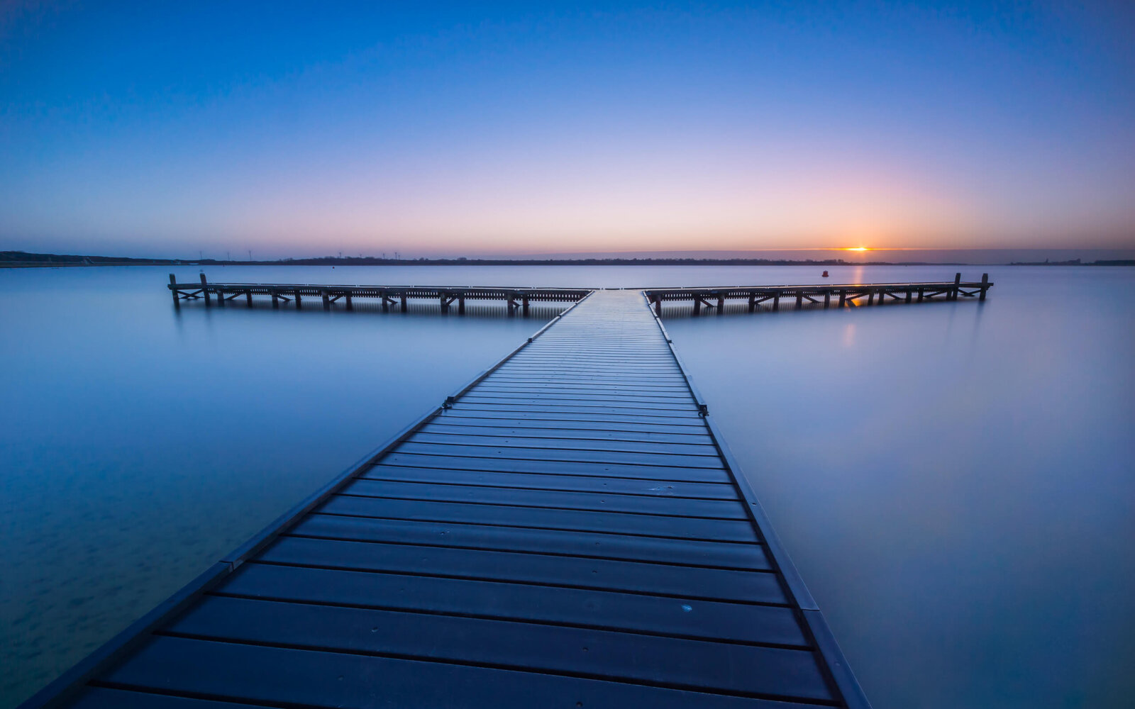On a quiet, calm morning at sunrise at a jetty on the Veerse Meer.