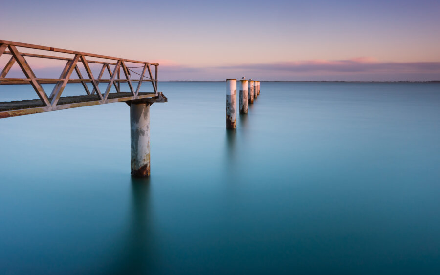 A metal pier with the setting sun, near the Oosterschelde, on Neeltje Jans.