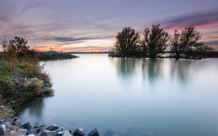 Alblasserdam Sunset by the river near Alblasserdam. Taken with a long exposure time, making the river look like a mirror.