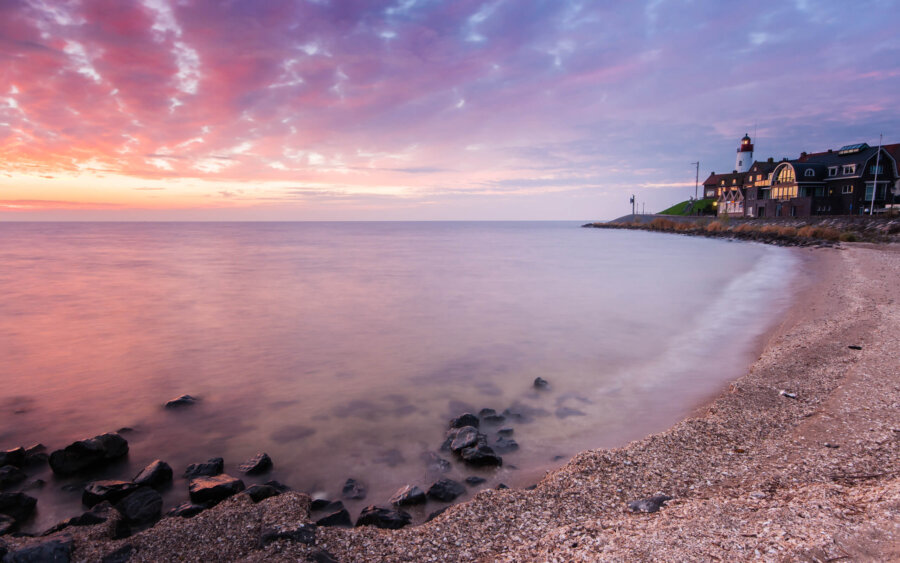 A beautiful sunset on the beach in Urk, with a view of the lighthouse.