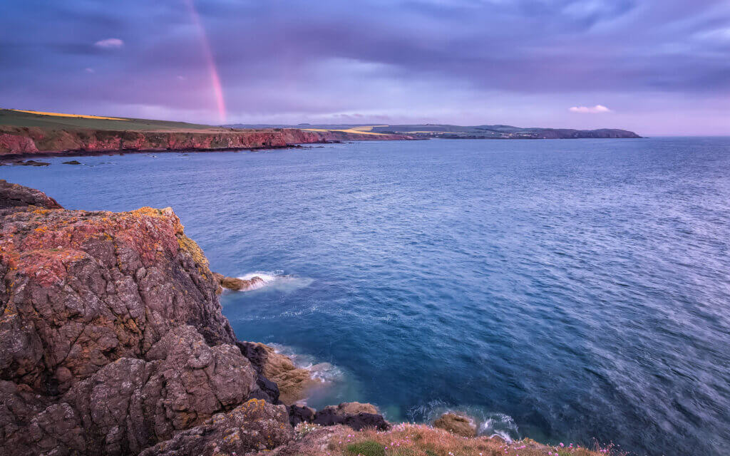 A rainbow with a threatening sky over the coastline of Eyemouth.