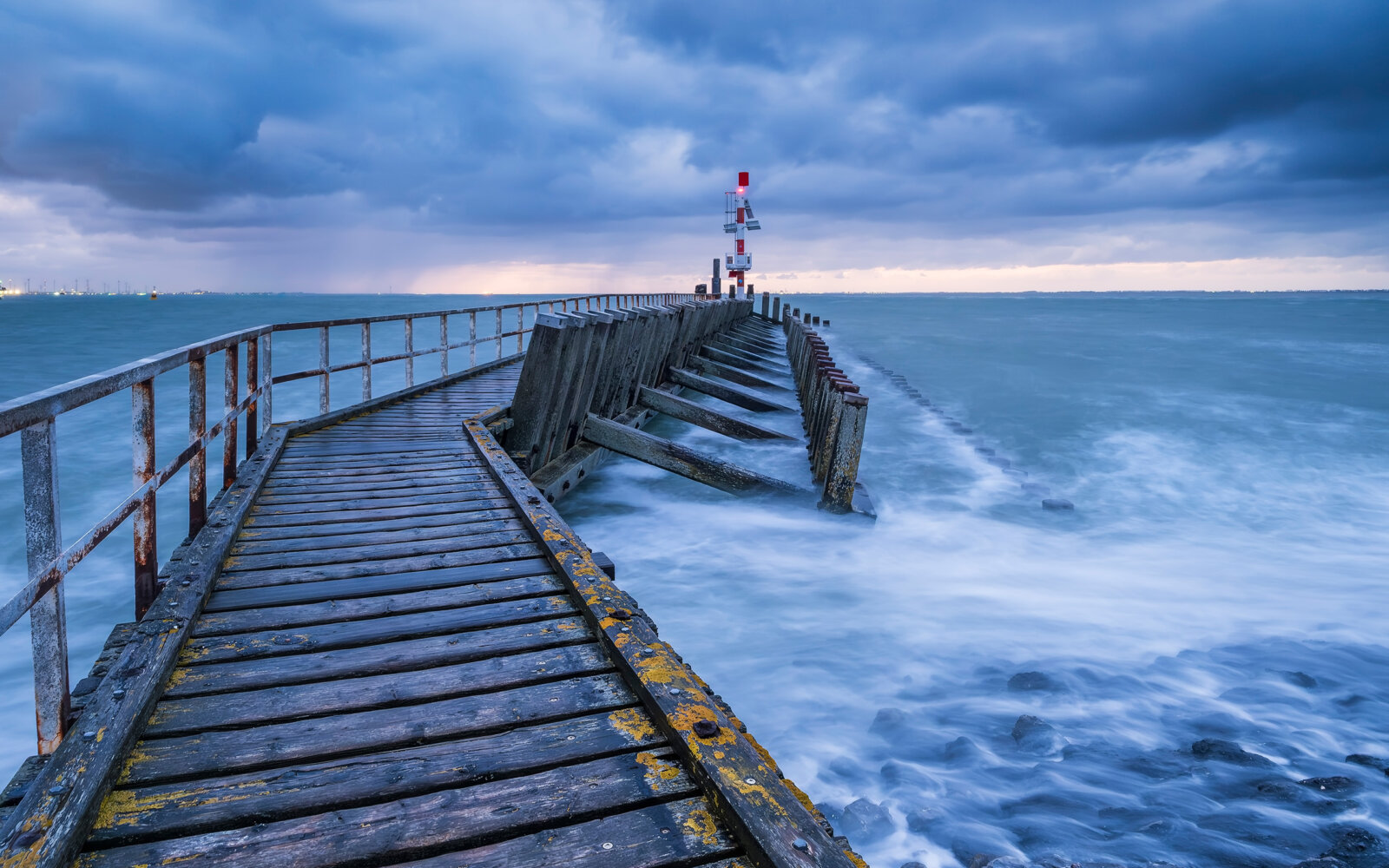One early morning, before sunrise, at the harbour buoy of the Outer Harbour in Vlissingen. A beautiful view of the Western Scheldt during a force 7 gale.