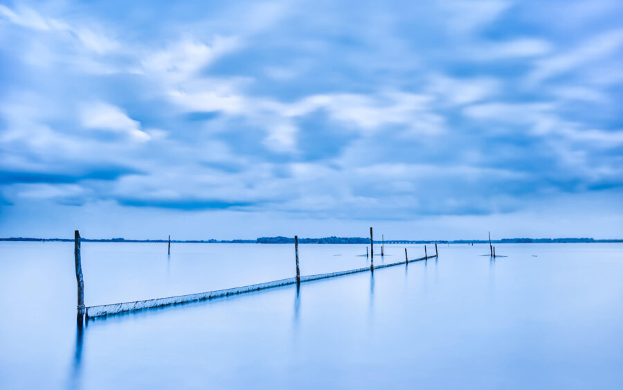 Biddinghuizen On a cloudy day, a long exposure photo with fishing nets in the Veluwemeer.